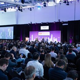 Conference session at NRF 2025 bringing together a large audience of retail professionals for inspiring discussions on industry challenges.