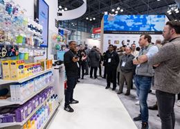Group of attendees on a guided tour of the NRF exhibition floor.