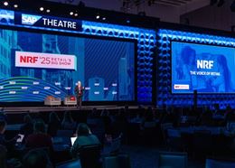 Keynote session at NRF Retail’s Big Show, with speaker on stage addressing a large audience.